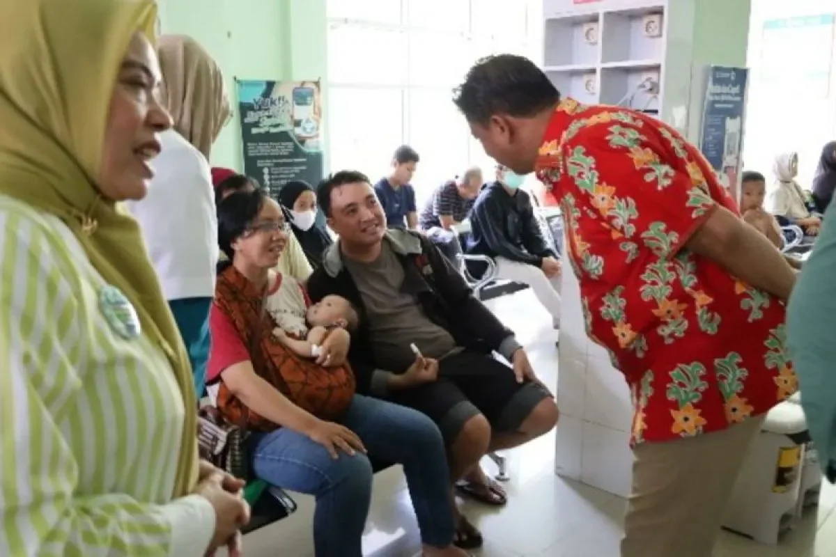 Sekda Kukar Sunggono (batik merah), berbincang dengan pengunjung Puskesmas Rapak Mahang, Kelurahan Timbau, Kecamatan Tenggarong, Kukar, Kaltim. (ANTARA)