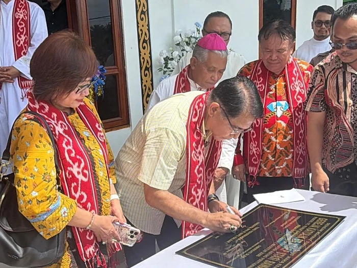 TANDATANGANI -Anggota DPR RI dari Fraksi Partai Golkar Dapil Kalimantan Barat I, Franciscus Maria Agustinus Sibarani saat menandatangani Prasasti Peresmian Gereja Stasi Santo Yosef Pekerja Bawat Dusun Basopa, Desa Pahokng, Kecamatan Mempawah Hulu, Kabupat