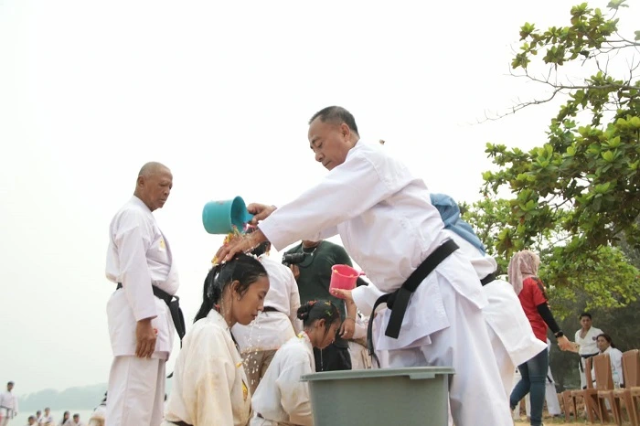 Ketua Umum Institut Karate-Do Nasional (INKANAS) Kalbar, Krisantus Kurniawan saat melakukan penyematan sabuk hitam dan kenaikan tingkat karateka INKANAS di Pantai Pak Lotay, Kota Singkawang, Minggu (18/10/2026).